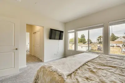 a bedroom with a bed and a flat screen tv at Chowchilla Home with Private Patio! in Chowchilla