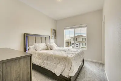 a bedroom with a bed and a window at Chowchilla Home with Private Patio! in Chowchilla