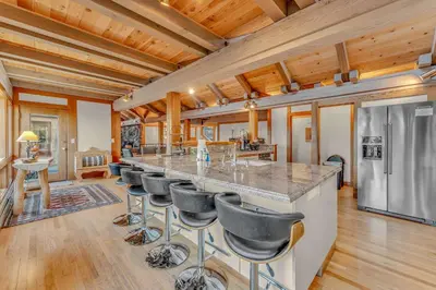 a kitchen with a long bar with stools at 3-Level Getaway Minutes from Lake Tahoe in Tahoe City