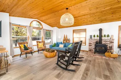 a living room with a blue couch and a fireplace at Lovely Home in Pollock Pines with Hot Tub in Pollock Pines