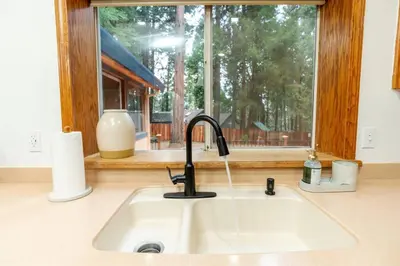 a kitchen sink in front of a window at Lovely Home in Pollock Pines with Hot Tub in Pollock Pines