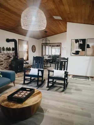 a living room with chairs and a wood stove at Lovely Home in Pollock Pines with Hot Tub in Pollock Pines