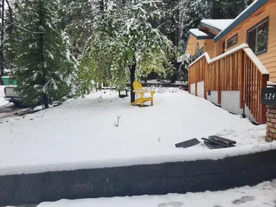 a yard covered in snow next to a building at Lovely Home in Pollock Pines with Hot Tub in Pollock Pines