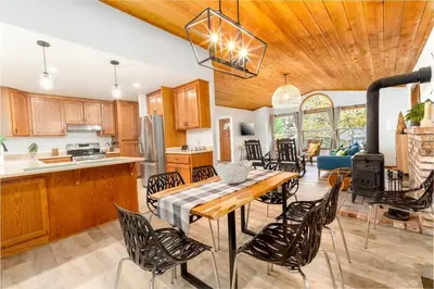 a kitchen and dining room with a table and chairs at Lovely Home in Pollock Pines with Hot Tub in Pollock Pines