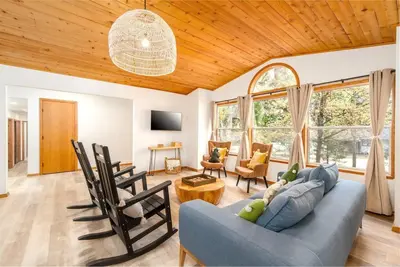 a living room with a blue couch and chairs at Lovely Home in Pollock Pines with Hot Tub in Pollock Pines
