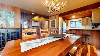a kitchen with a wooden table and a dining room at Woodlands #40 condo in Mammoth Lakes