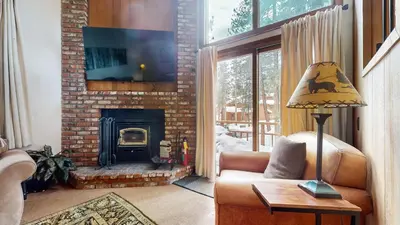 a living room with a couch and a fireplace at Woodlands #40 condo in Mammoth Lakes