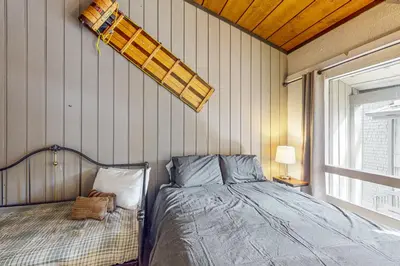 a bedroom with a bed and a fire hydrant on the wall at Sierra Park Villas 56 L in Mammoth Lakes