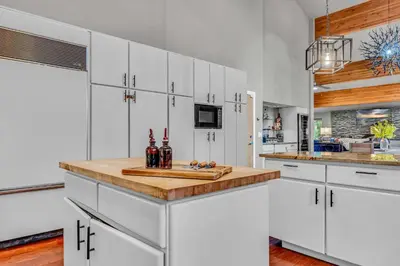 a kitchen with white cabinets and a wooden counter top at Upscale Incline Village Home with Hot Tub & Sauna in Incline Village