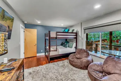 a bedroom with a bunk bed and two chairs at Upscale Incline Village Home with Hot Tub & Sauna in Incline Village