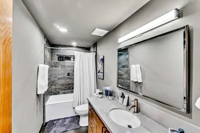 a bathroom with a sink and a toilet and a mirror at Upscale Incline Village Home with Hot Tub & Sauna in Incline Village