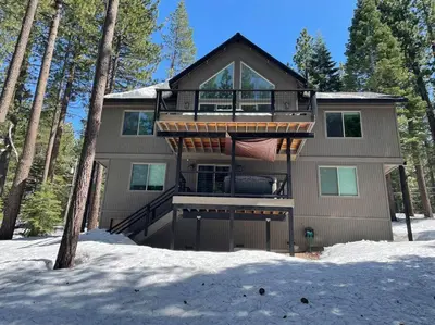 a large house with a deck in the snow at Grandview Manor - Luxury - Hot tub - Stylish in South Lake Tahoe