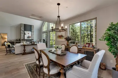 a dining room and living room with a table and chairs at Grandview Manor - Luxury - Hot tub - Stylish in South Lake Tahoe