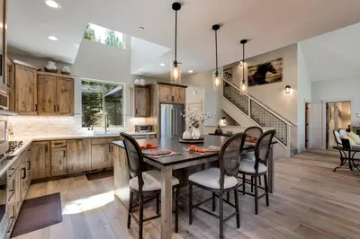 a kitchen with a table and chairs and a staircase at Grandview Manor - Luxury - Hot tub - Stylish in South Lake Tahoe