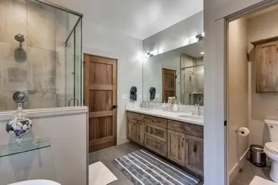 a bathroom with two sinks and a shower and a toilet at Grandview Manor - Luxury - Hot tub - Stylish in South Lake Tahoe