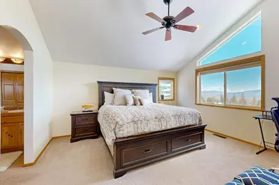 a bedroom with a bed and a ceiling fan at Skislope Serenity in Truckee