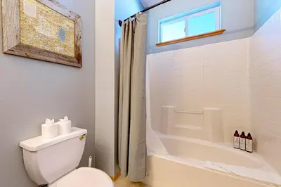 a bathroom with a white toilet and a shower at Skislope Serenity in Truckee