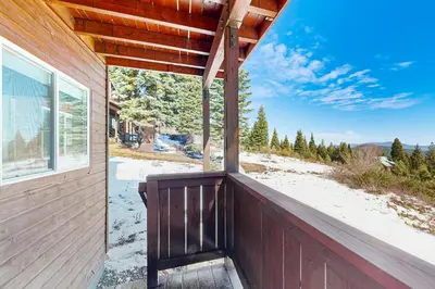 a porch with a bench on the side of a house at Skislope Serenity in Truckee