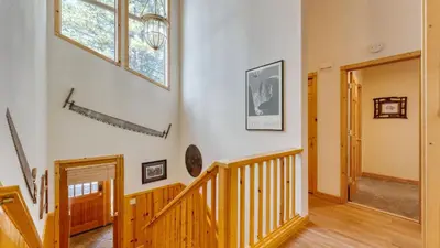 a wooden staircase in a house with a window at Hansel by AvantStay Pool Table 5mins to Skiing in Truckee
