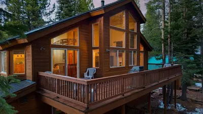 a cabin in the woods with a large deck at Hansel by AvantStay Pool Table 5mins to Skiing in Truckee