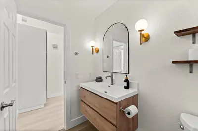 a bathroom with a sink and a mirror at Recently Upgraded House with King Suite, quiet NBHD, Fast Wifi, and Yard in Elk Grove