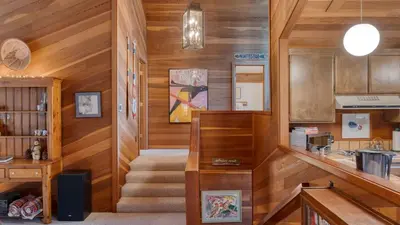 a hallway with wooden walls and stairs in a house at Northstar Hideaway by AvantStay 5mins to Skiing in Truckee