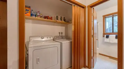 a small laundry room with a washer and dryer at Northstar Hideaway by AvantStay 5mins to Skiing in Truckee