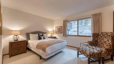 a bedroom with a bed and a chair and a window at Northstar Hideaway by AvantStay 5mins to Skiing in Truckee