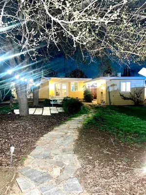 a campsite at night with a yellow caravan at 2 Private Bedroom Suites with Hot Tub in Sacramento
