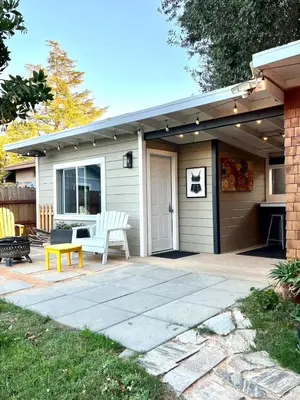 a patio with a white bench and a house at 2 Private Bedroom Suites with Hot Tub in Sacramento