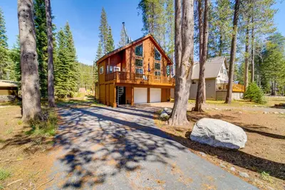 a log home in the woods with a driveway at Snowshoe and Sled On-Site! Soda Springs Cabin in Soda Springs