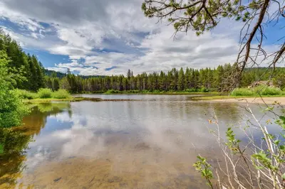a body of water with trees in the background at Snowshoe and Sled On-Site! Soda Springs Cabin in Soda Springs