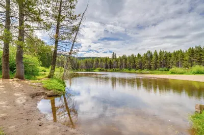 a river with trees on the side of it at Snowshoe and Sled On-Site! Soda Springs Cabin in Soda Springs