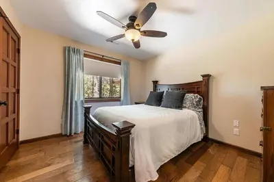 a bedroom with a bed with a ceiling fan at Northstar Family Retreat on Shuttle Line with Deck in Truckee