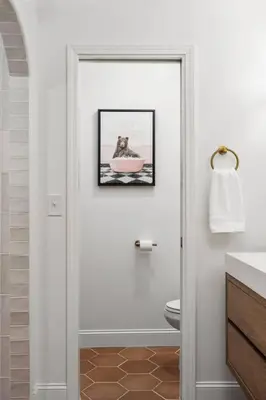 a bathroom with a toilet and a picture on the wall at Stunning views with pool, spa, gold panning, firepit, game court and BBQ in Ahwahnee