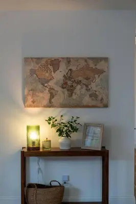 a table with a plant and a map on the wall at Stunning views with pool, spa, gold panning, firepit, game court and BBQ in Ahwahnee