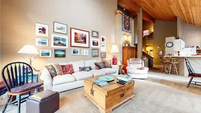 a living room with a white couch and a table at Snowcreek IV #545 condo in Mammoth Lakes