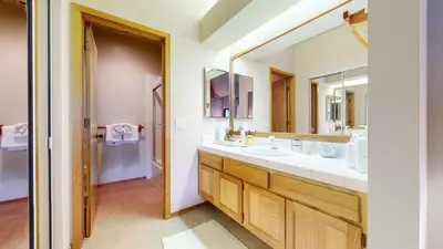 a bathroom with two sinks and a large mirror at Snowcreek IV #545 condo in Mammoth Lakes
