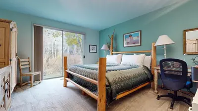 a bedroom with a bed and a desk and a window at Snowcreek IV #545 condo in Mammoth Lakes