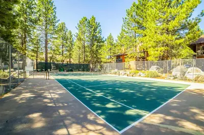 a tennis court with a net on it at La Residence M9 in Mammoth Lakes