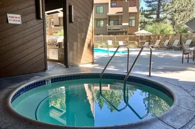 a pool with a hot tub in the middle of a building at Wildflower 47 in Mammoth Lakes