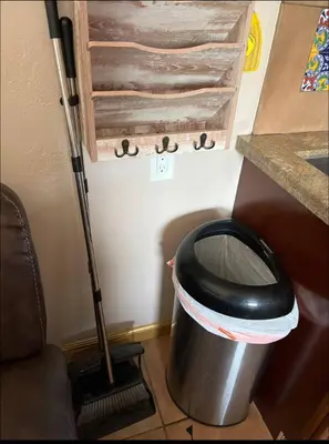 a trash can in a kitchen with a broom at Charming Casita all too yourself near Midtown, Train and Freeway in Sacramento