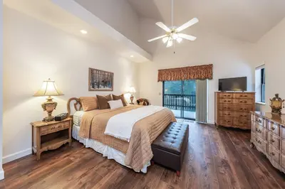 a bedroom with a large bed and a television at Granite Ridge Getaway Chill Deck Vibes AC in Shaver Lake