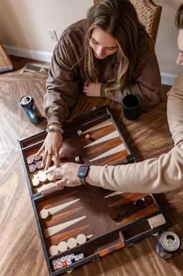 a woman and man playing a game on a table at Granite Ridge Getaway Chill Deck Vibes AC in Shaver Lake