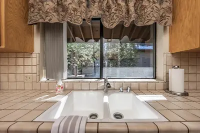 a large white sink in front of a window at Granite Ridge Getaway Chill Deck Vibes AC in Shaver Lake