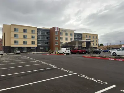 an empty parking lot in a parking lot with buildings at Fairfield Inn & Suites Livermore in Livermore