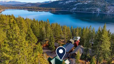 an aerial view of a house with a crane on top of a lake at Denton by AvantStay Hot Tub Deck w Fire Pit Near Skiing Lake in Truckee