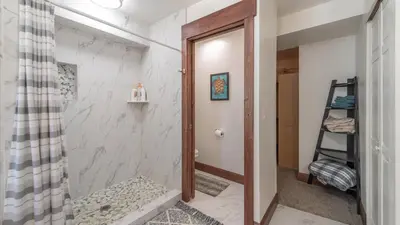 a bathroom with a shower and a walk in shower at Denton by AvantStay Hot Tub Deck w Fire Pit Near Skiing Lake in Truckee