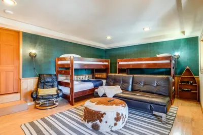 a living room with two bunk beds and a couch at 6 Mi to Ski Slopes! Family Tahoe Cabin with 3 Decks in Tahoe Vista