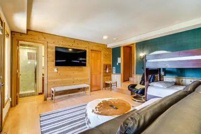 a bedroom with a bed and a couch and a tv at 6 Mi to Ski Slopes! Family Tahoe Cabin with 3 Decks in Tahoe Vista